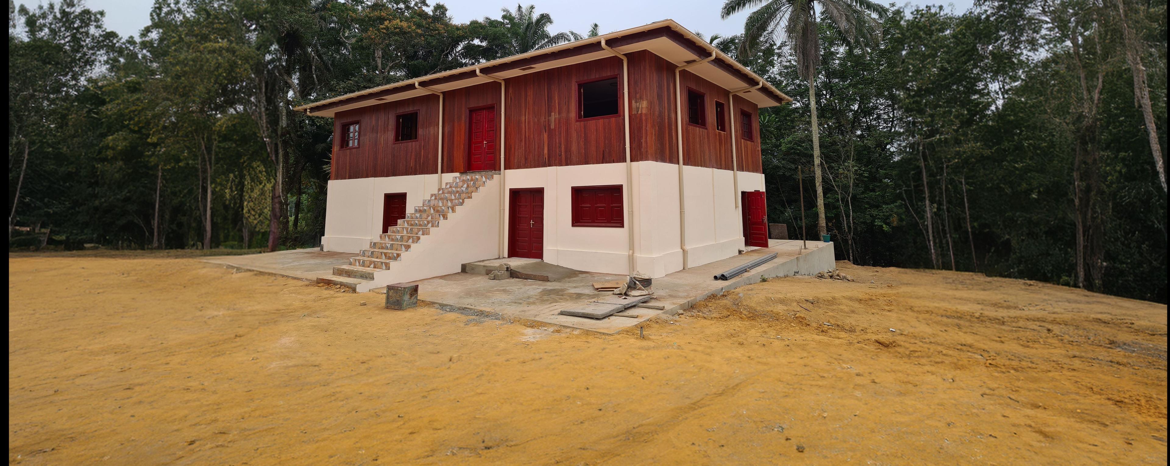 A two floored building outside in nature in Gabun